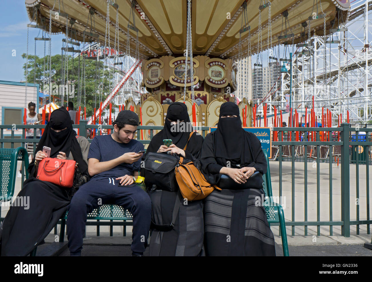 A Muslim family with women in burkas at Luna Park in Coney Island, Brooklyn, New York. Stock Photo