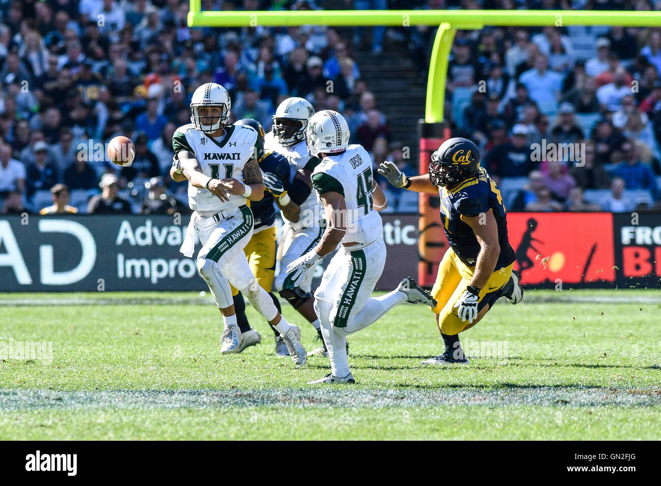 Hawaii wide receiver John Ursua (5), front, is dragged down by Colorado  State cornerback Anthony Hawkins after catching a pass for a touchdown in  the first half of an NCAA college football