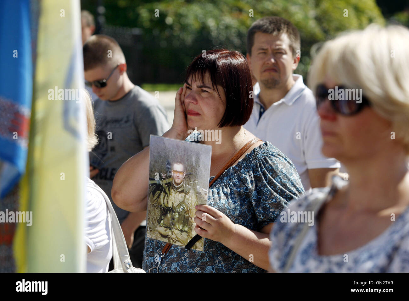 Kiev, Ukraine. 28th Aug, 2016. People hold portraits of killed and missing Ukrainian servicemen during the 2014 battle which took place in a small town Ilovaysk near Donetsk known as the battle of ''Ilovaisk kettle'', during a rally to mark the second anniversary of the battle, in Kiev, Ukraine, on 28 August 2016. According the Ukrainian Military prosecutor's office, 366 Ukrainian soldiers were lost and 158 were missing during heavy fighting between Ukrainian government forces and pro-Russian separatists near of Ilovaysk at August 2014 at the East of Ukraine. (Credit Image: © Serg Glovny via Stock Photo