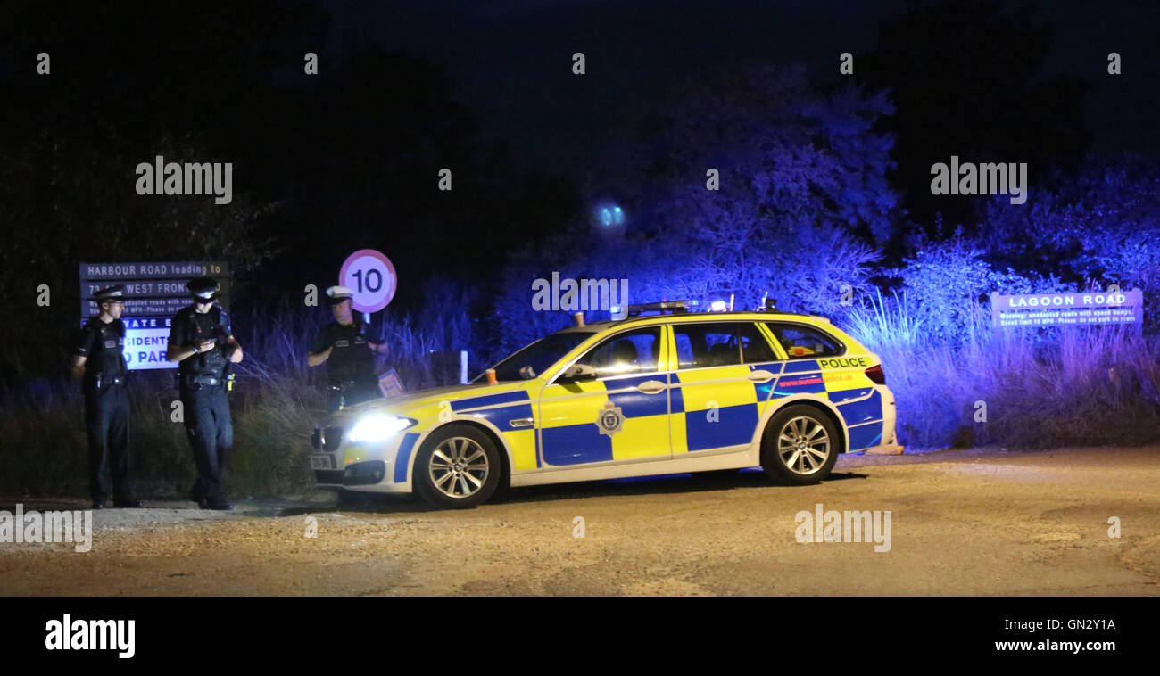 Pagham, West Sussex Sunday 28th August 2016. Emergency services were called to a property in Harbour Road, Pagham at around 4.10pm on Sunday (28 August) following reports a 72-year-old man was using threatening behaviour and armed with a gun. A woman known to the man was also in the house, but she has now left and is safe and well. There are no reported injuries. The 72-year-old man remains in the house alone. A police cordon has been set up around the house and the road has been closed. Officers, including firearms officers, remain at the scene while negotiations continue. © uknip/Alamy Live  Stock Photo