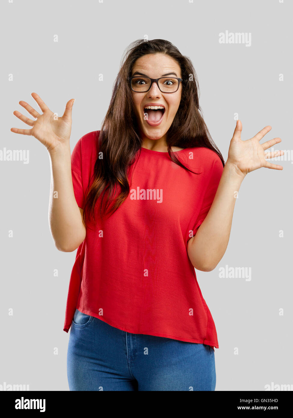 Happy woman with arms up, isolated over white background Stock Photo