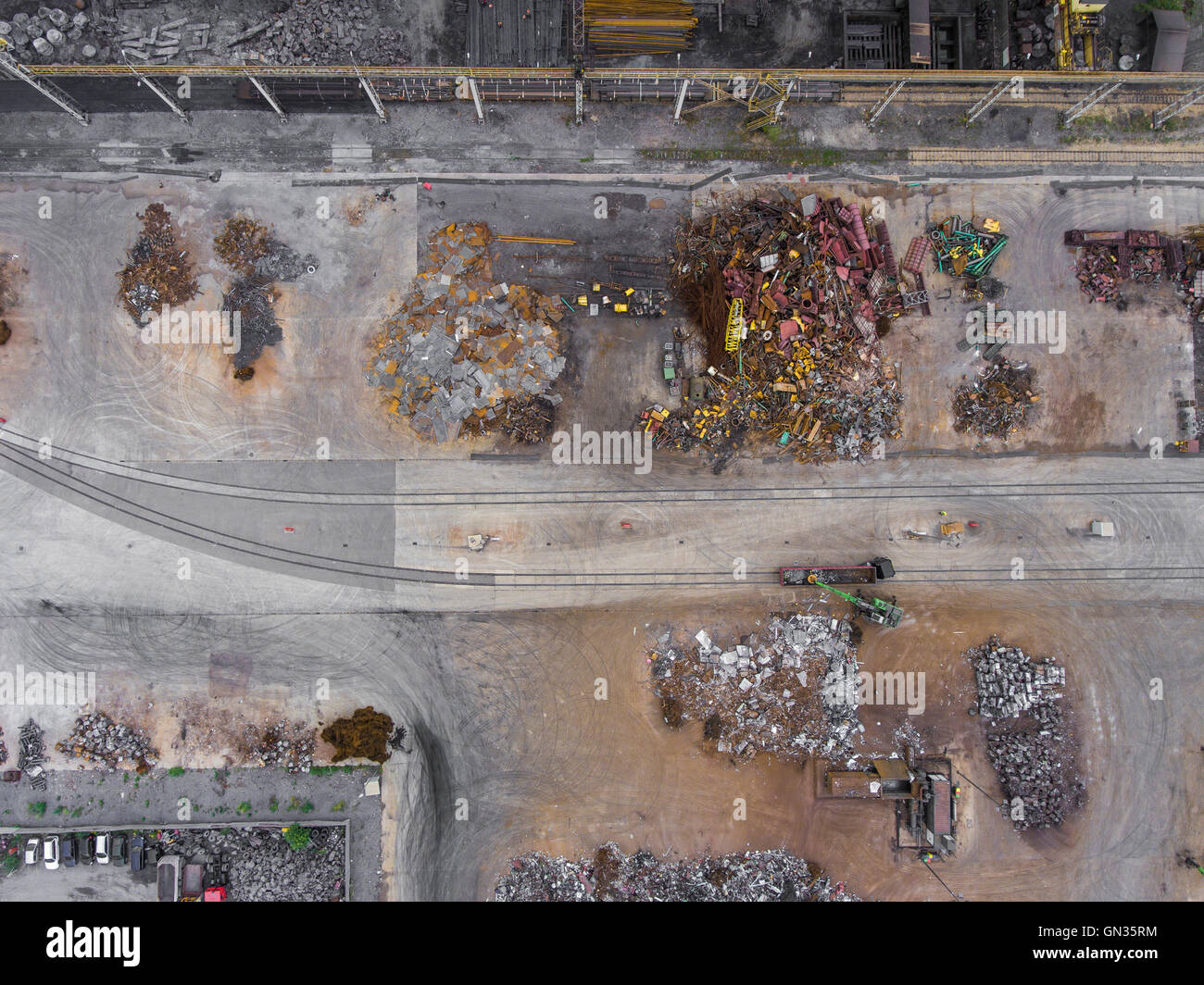 Iron raw materials recycling pile, work machines. Metal waste junkyard