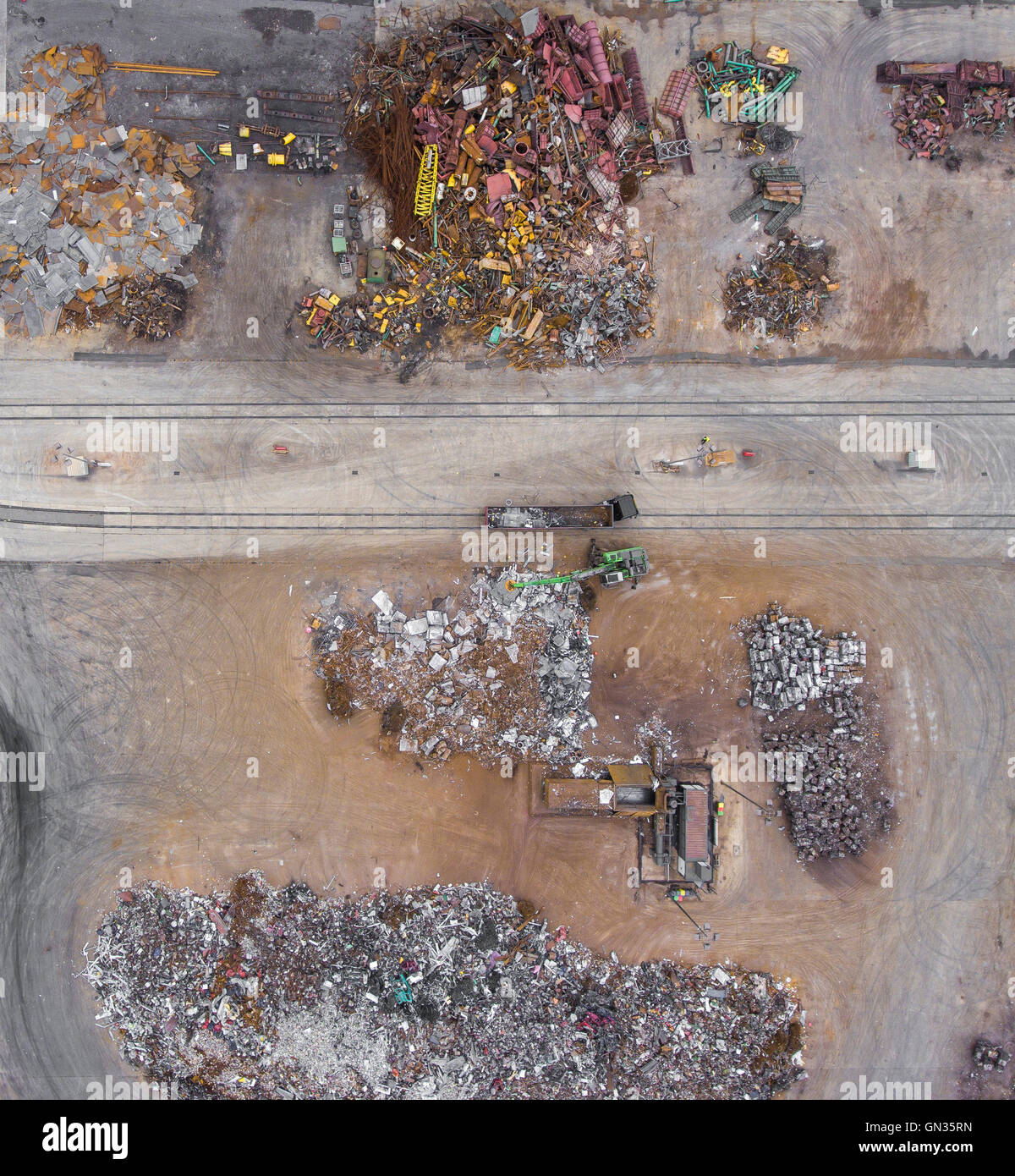 Iron raw materials recycling pile, work machines. Metal waste junkyard ...