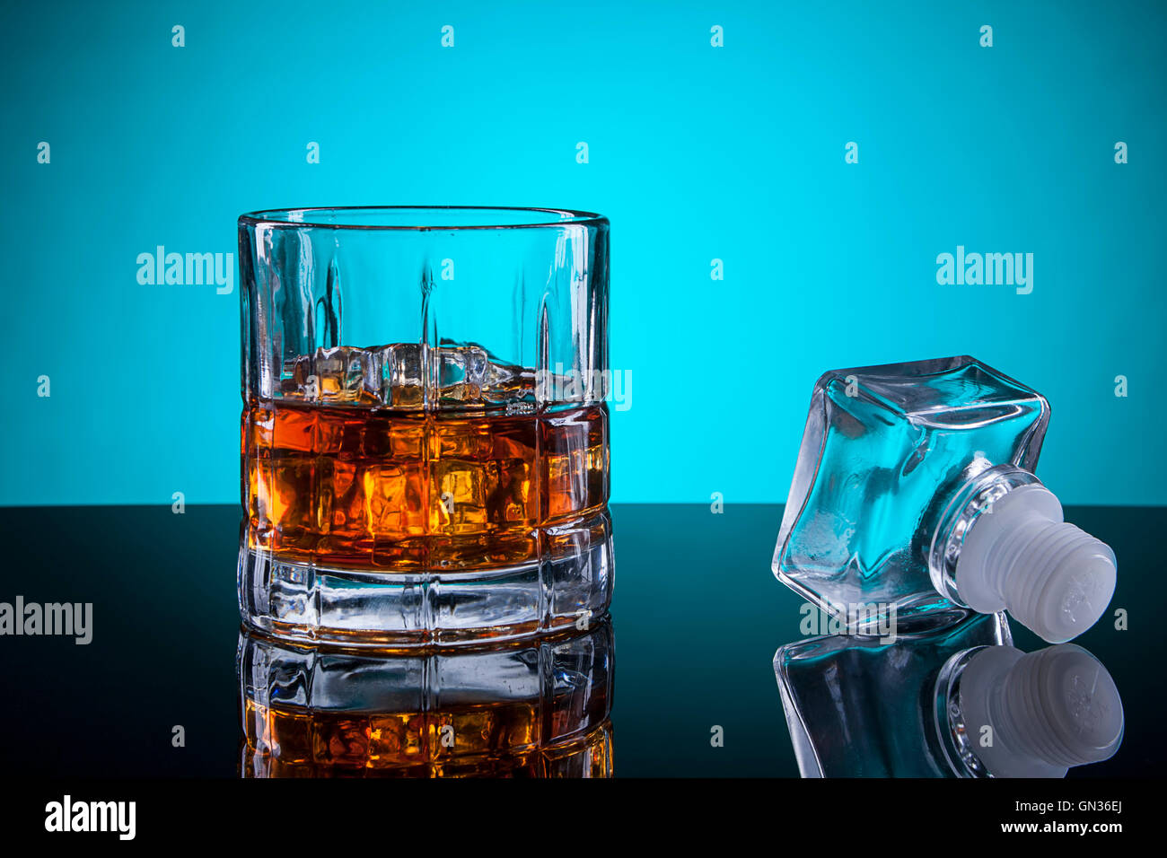 Glass of alcohol and the stopper. Stock Photo