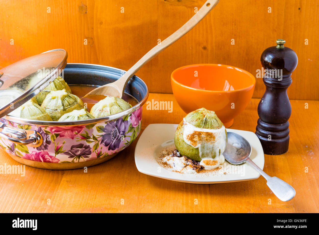 steamed round zucchini filled with meat and rice, seasoned with fragrant black pepper, topped with white sauce. Stock Photo