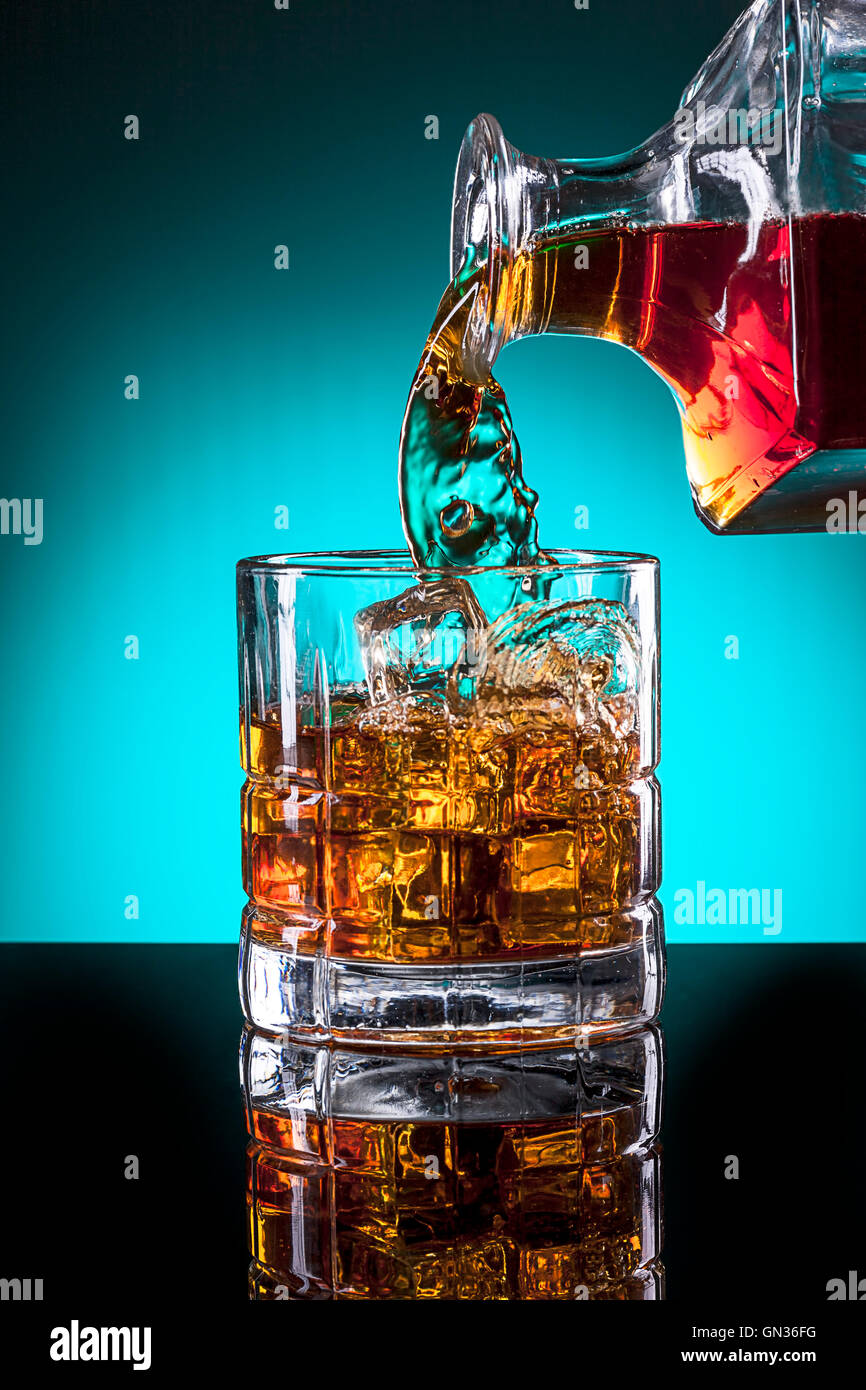 Glass of alcohol and glass bottle. Stock Photo