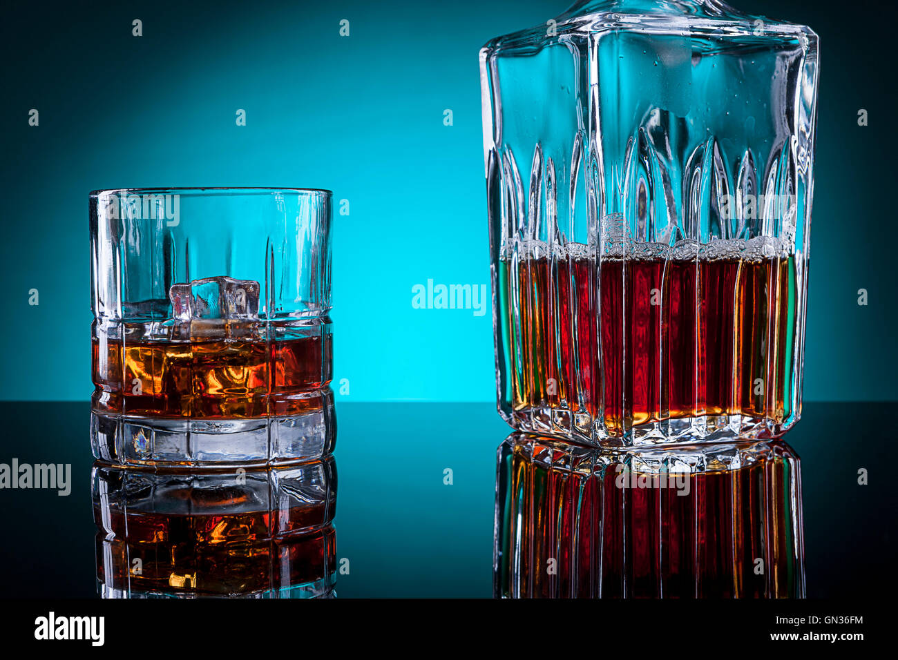 Glass of alcohol and glass bottle. Stock Photo