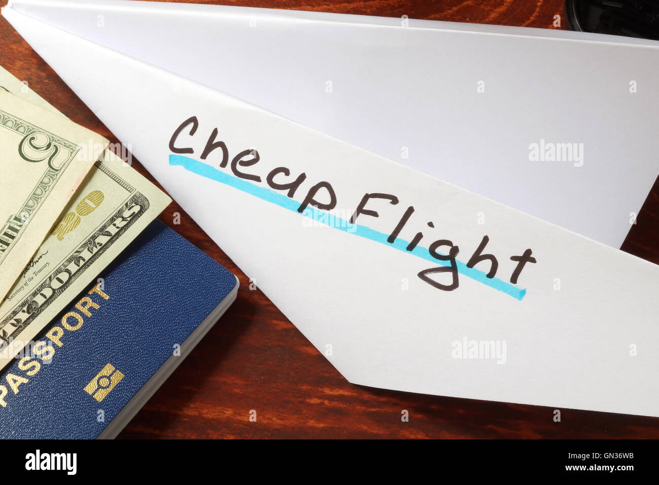 Paper plane with words cheap flight. Traveling concept. Stock Photo