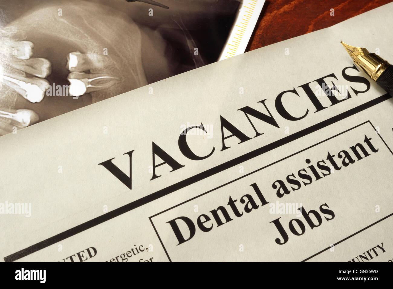 Newspaper with ads dental assistant jobs vacancy. Occupation concept. Stock Photo