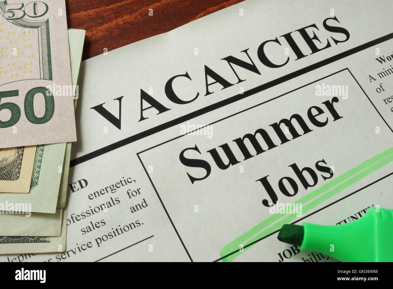 Newspaper with ads summer jobs vacancy. Occupation concept. Stock Photo
