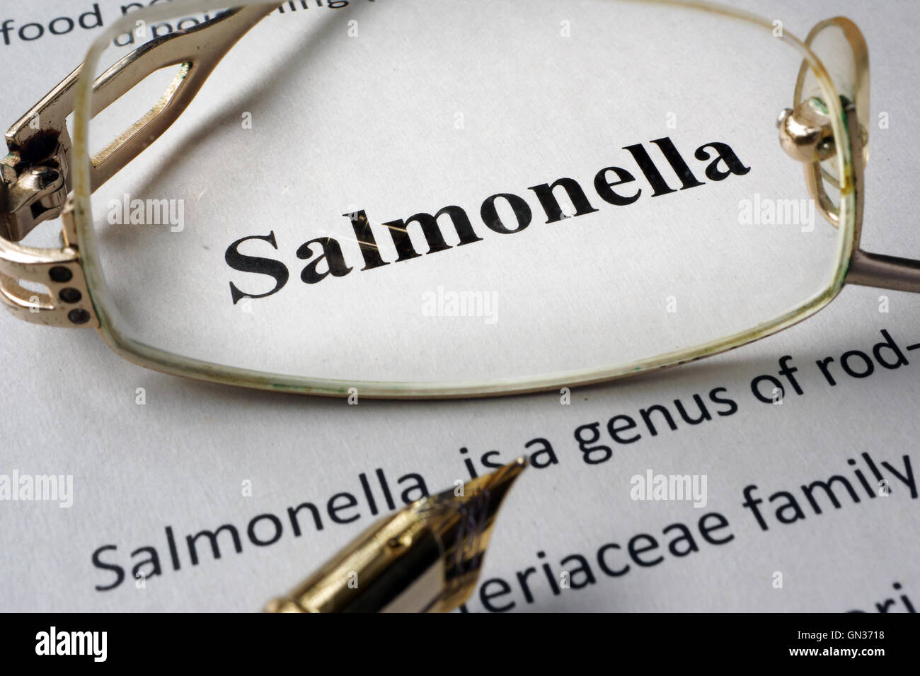 Page of hospital form with diagnosis Salmonella and glasses. Stock Photo