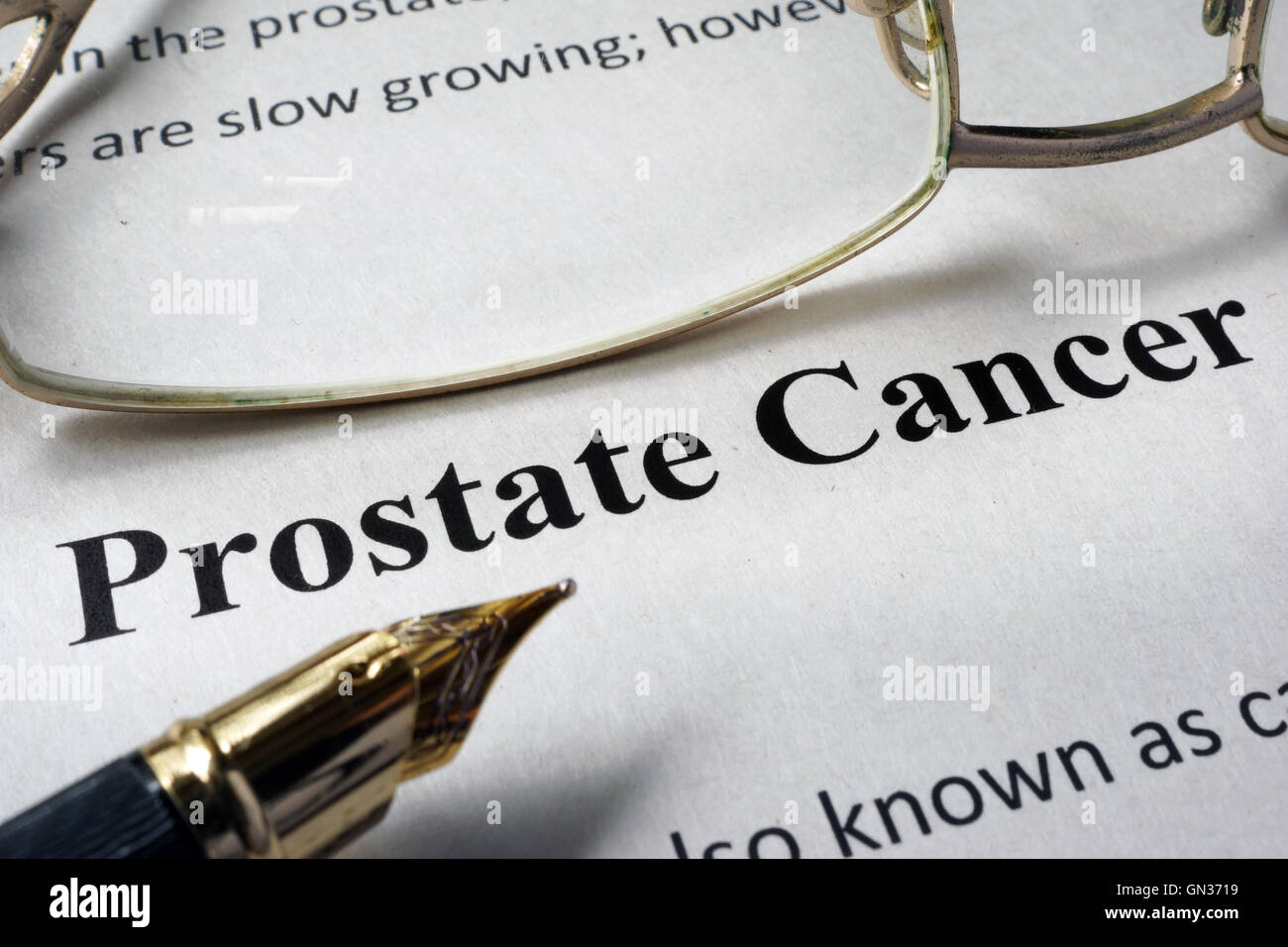 Page of hospital form with diagnosis prostate cancer and glasses. Stock Photo