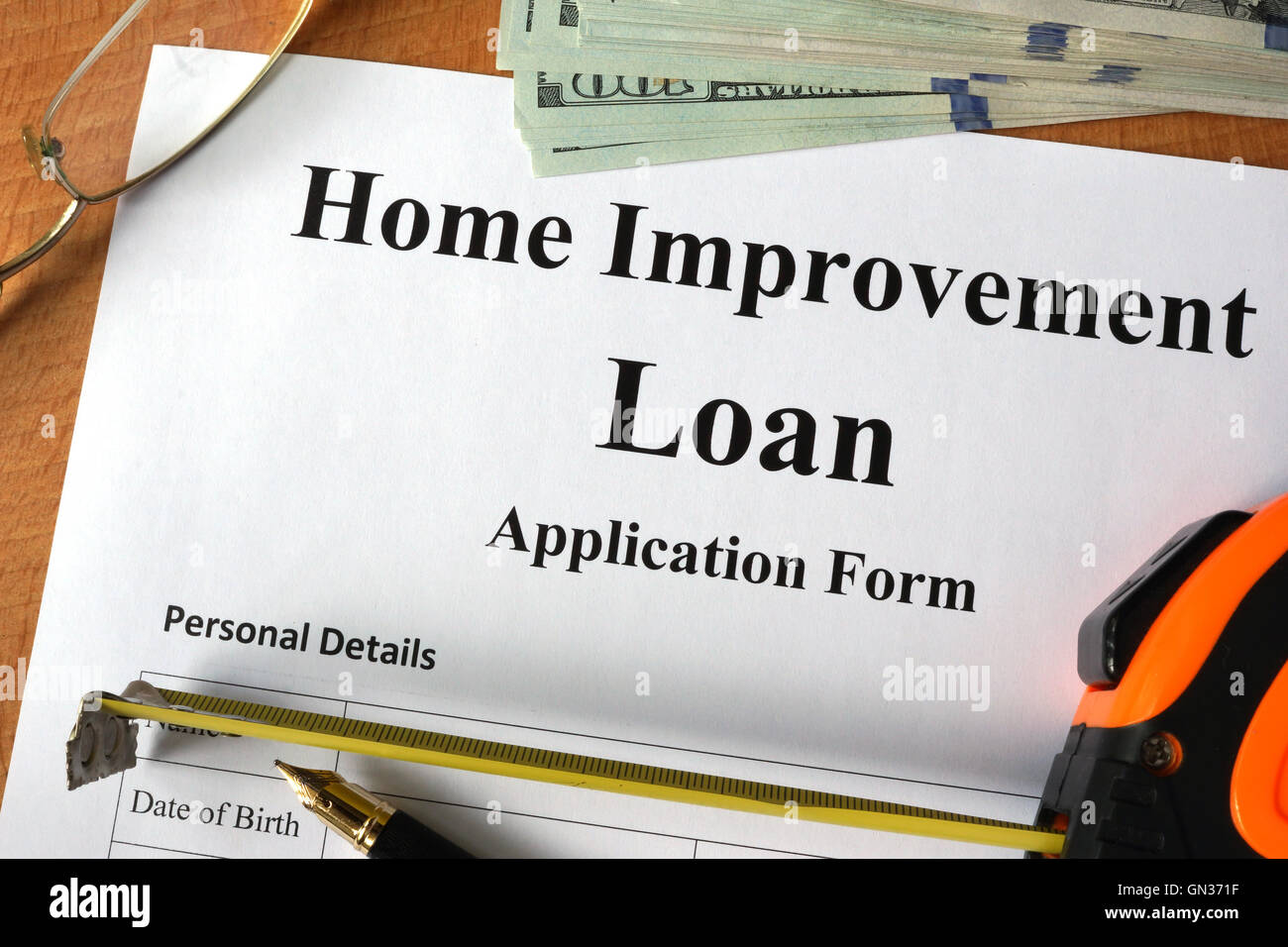 Home improvement loan form on a wooden table. Stock Photo