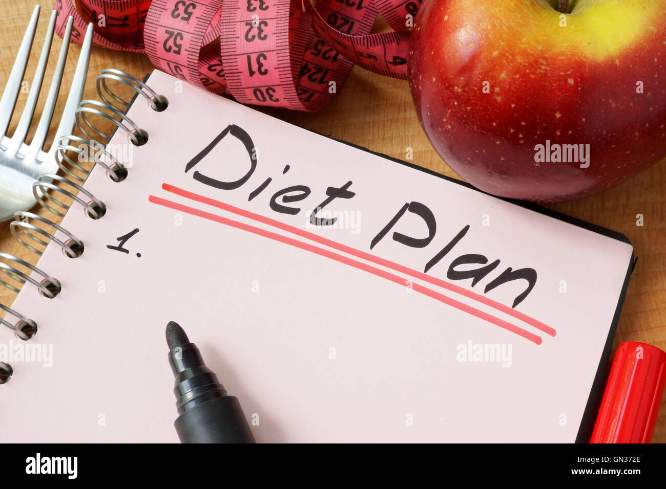 Diary with a record diet plan on a table. Stock Photo