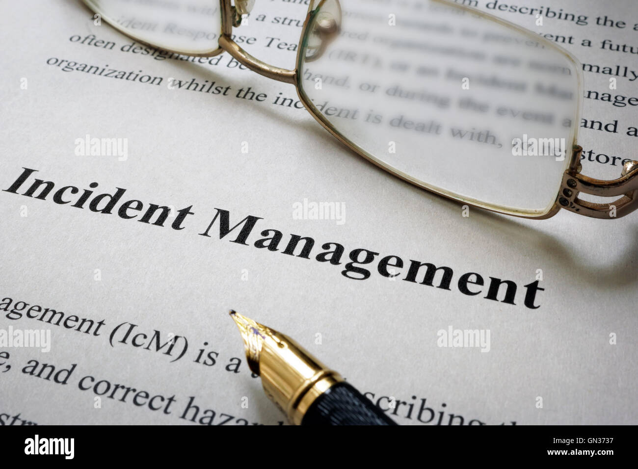 Page of paper with words Incident Management and glasses. Stock Photo