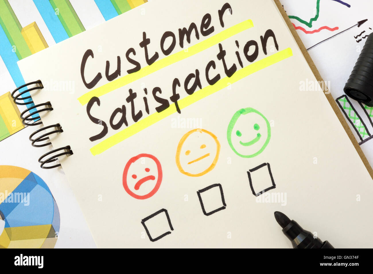 Sign customer satisfaction on a page of notebook. Stock Photo