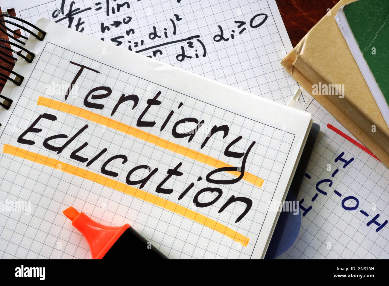 Sign tertiary education written in a notepad on a table. Stock Photo