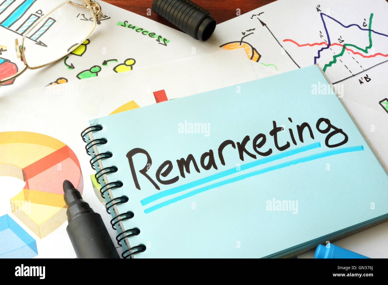 Remarketing written on a notepad sheet. Marketing concept. Stock Photo