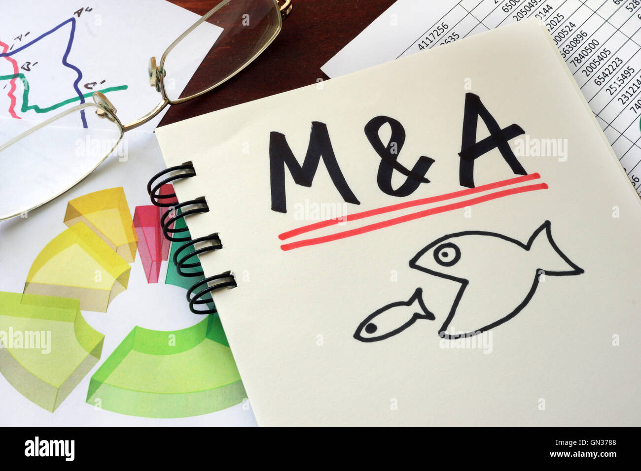 M&A Merger And Acquisitions written on a notepad with marker. Stock Photo