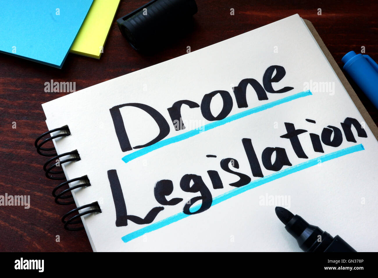 Drone Legislation written on a notepad with marker. Stock Photo