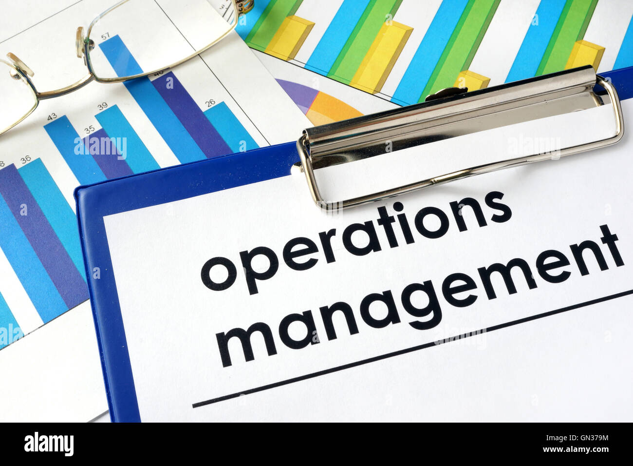 Paper with words operations management and charts. Stock Photo
