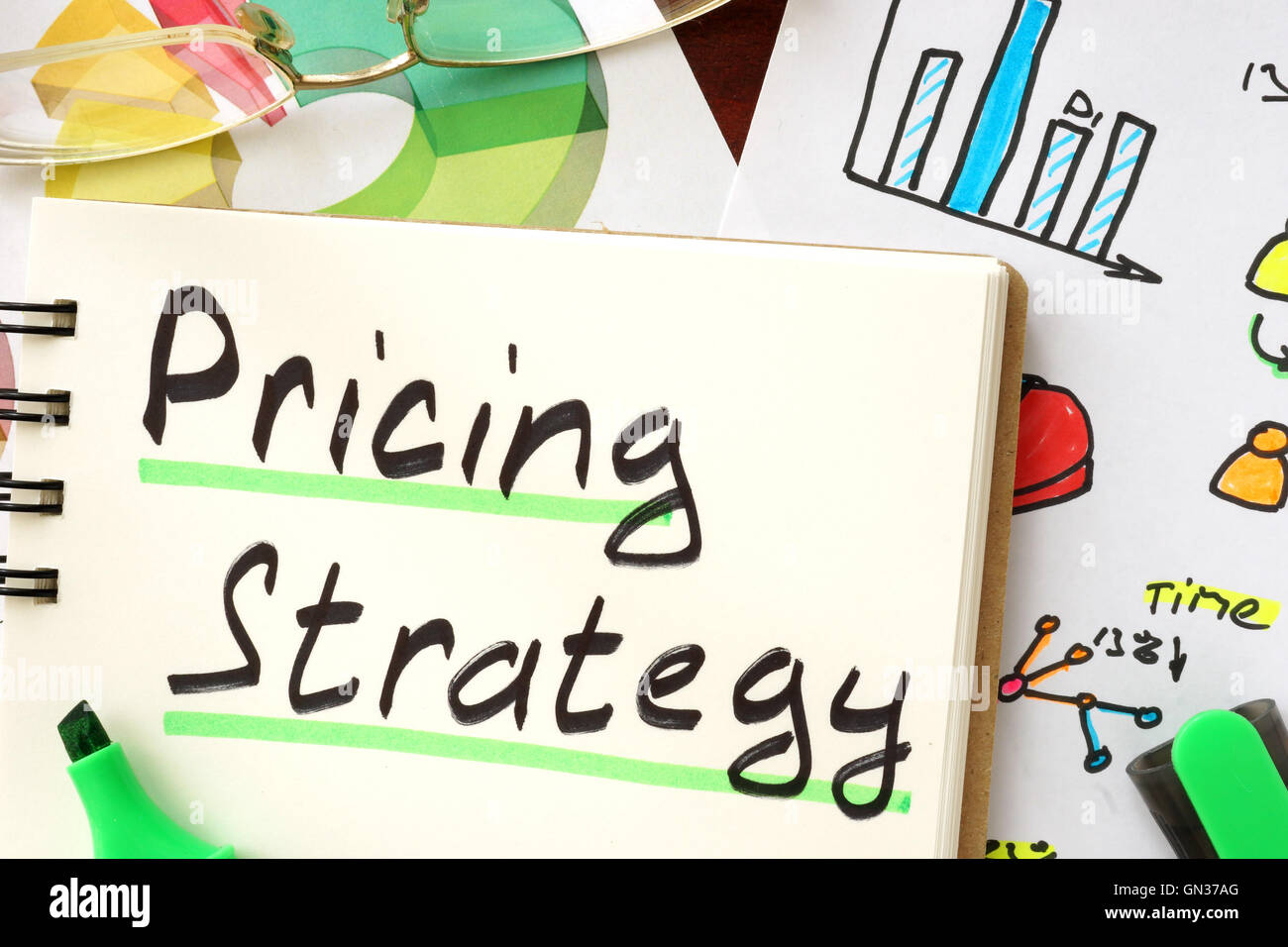 Pricing strategy sign written in a notepad. Stock Photo