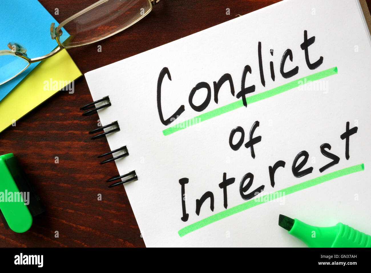 Conflict of interest sign written in a notepad. Stock Photo