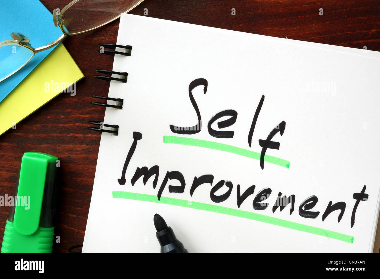 Self improvement sign written in a notepad. Stock Photo