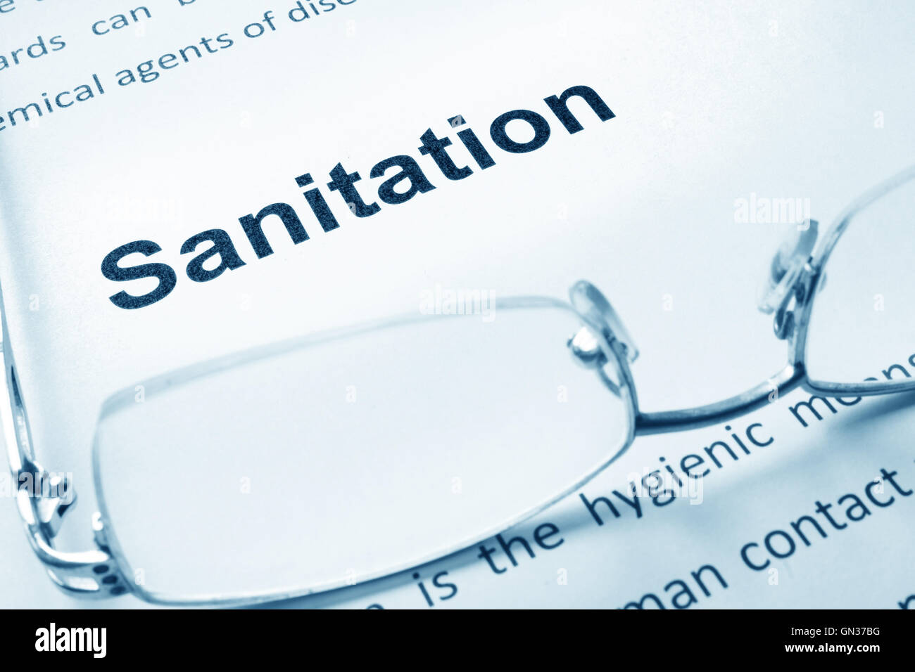 Sanitation sign on a paper and glasses. Stock Photo