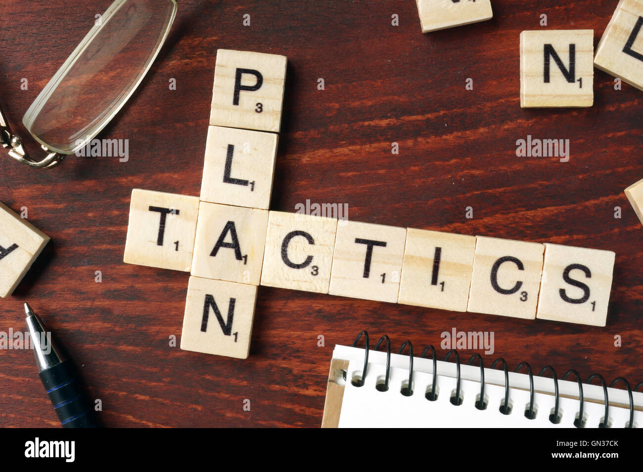 Words Plan Tactics from wooden blocks with letters. Stock Photo