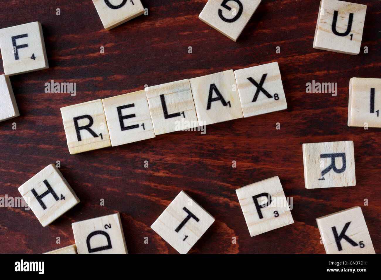 Word relax from wooden blocks with letters. Stock Photo