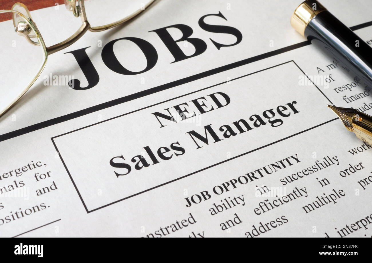 Newspaper with ads for vacancy sales manager. Employment concept. Stock Photo
