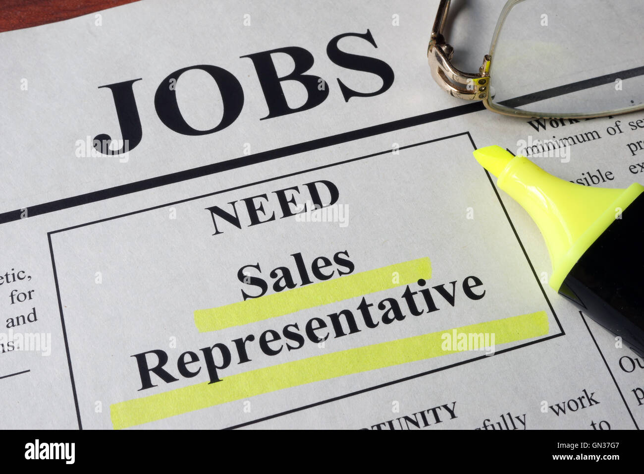Newspaper with ads for vacancy sales representative. Employment concept. Stock Photo