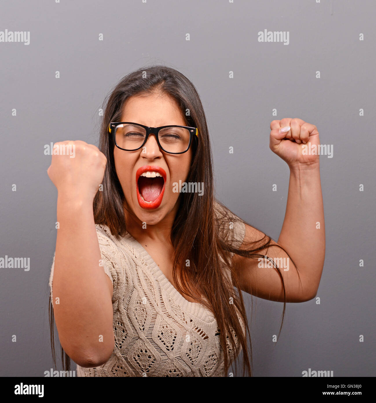 Portrait of happy woman exults pumping fists ecstatic celebrates ...