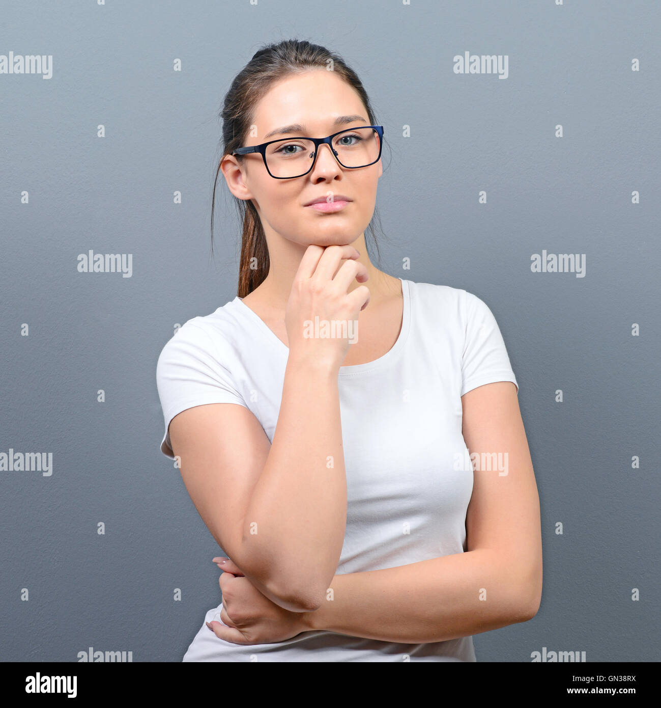 Portrait of a smiling business woman against gray background Stock ...