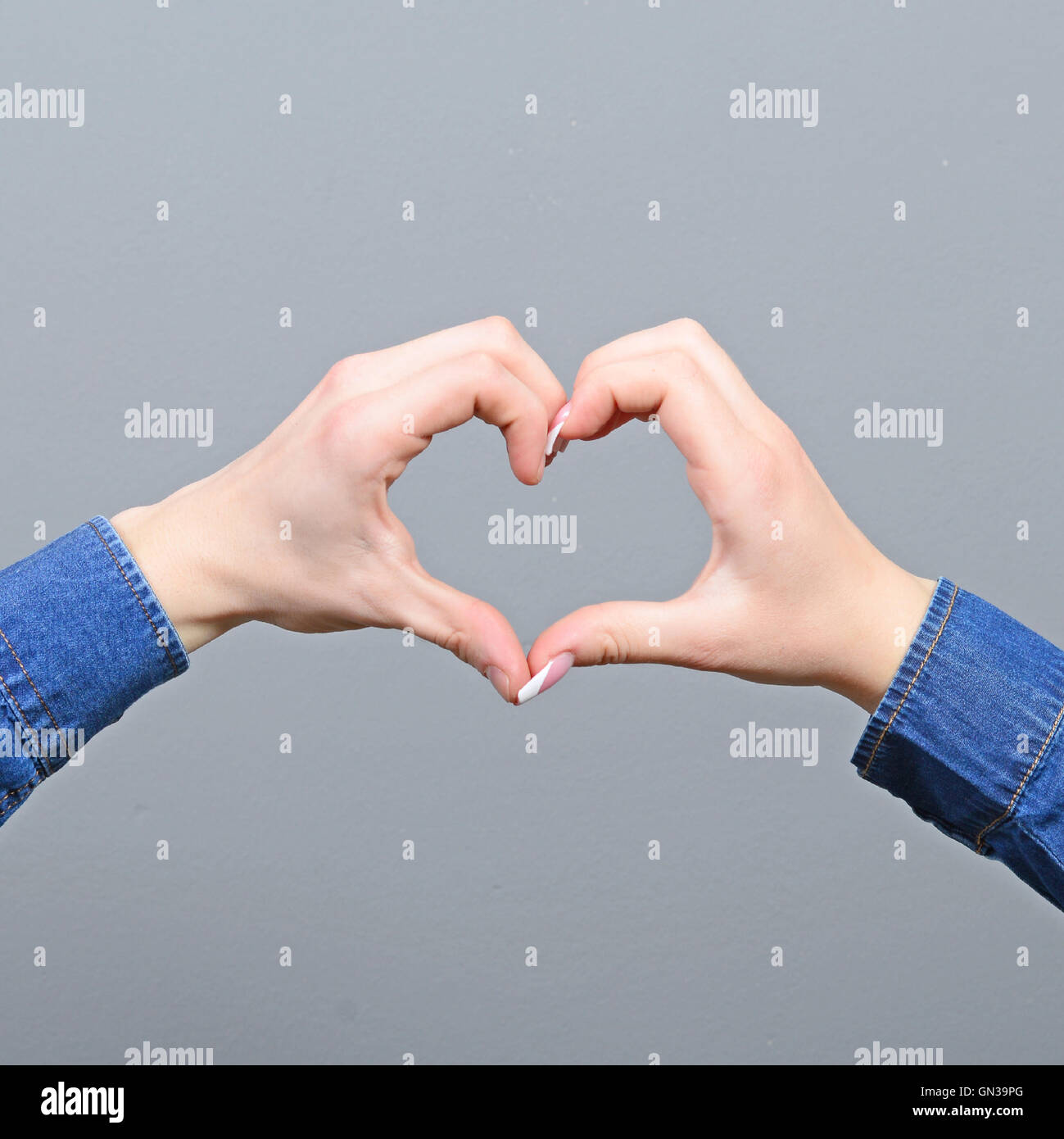 Couple making heart shape with hands Stock Photo - Alamy