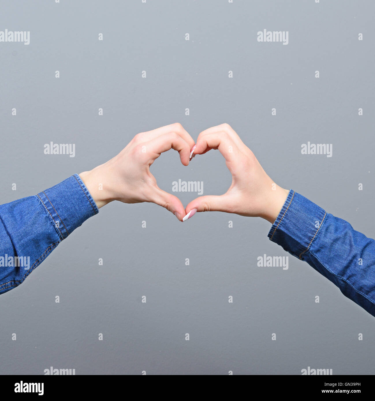 Couple making heart shape with hands Stock Photo - Alamy