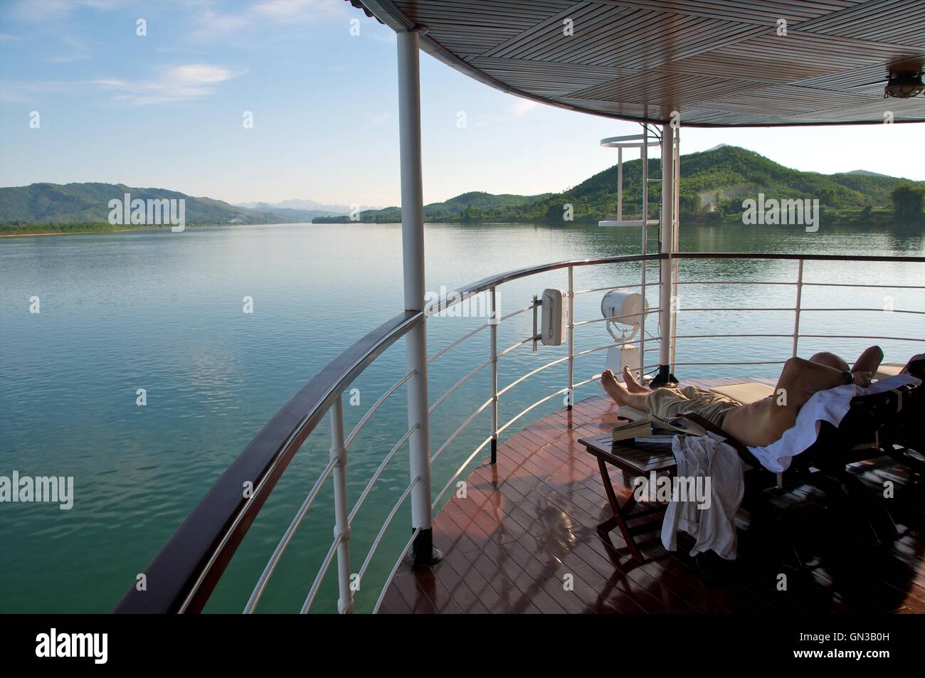 Red River, Vietnam - 17 November 2015. Enjoying the unfolding view along the Red River from the deck of a cruise ship. Stock Photo