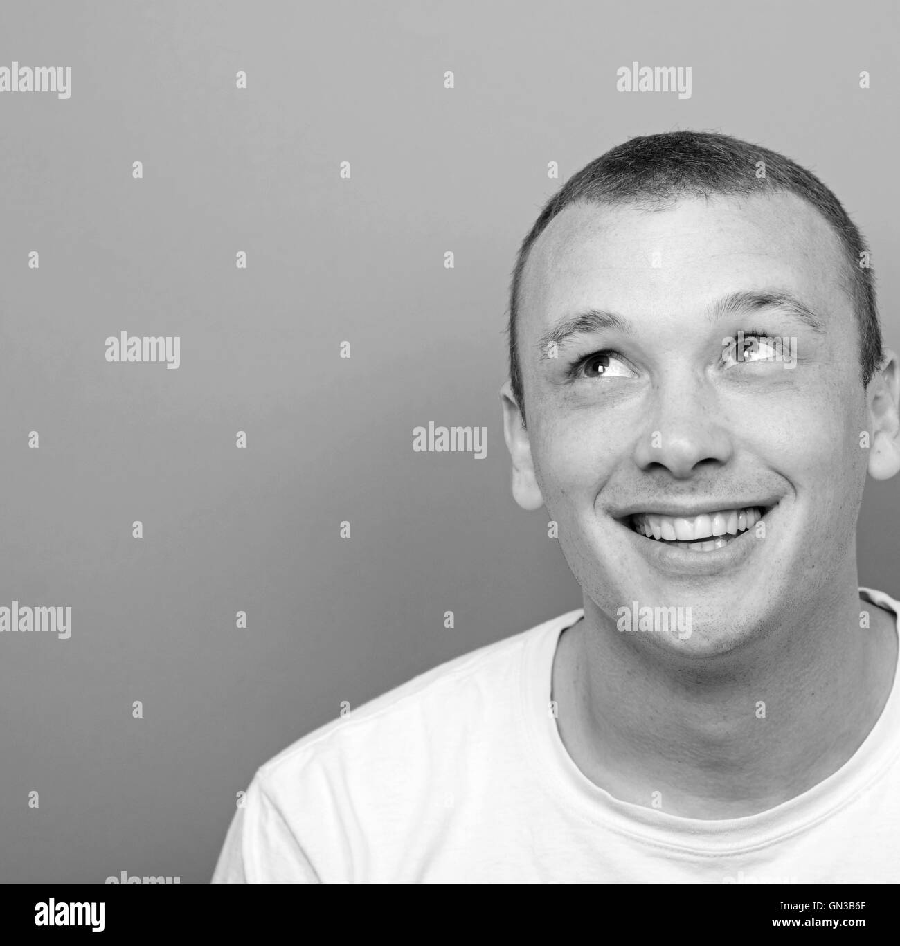 Portrait of happy young man looking up Stock Photo - Alamy