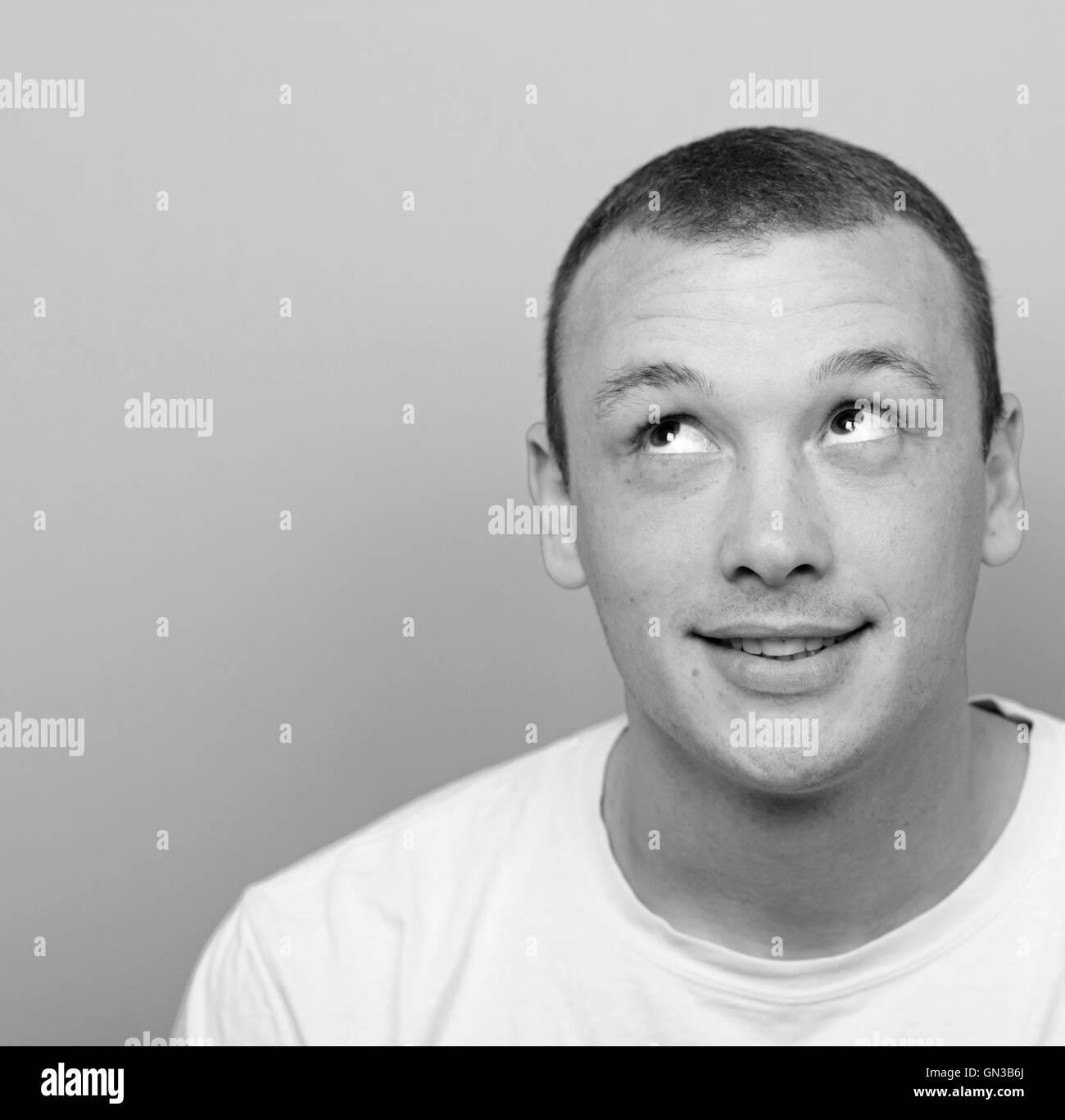 Portrait of happy young man looking up Stock Photo - Alamy