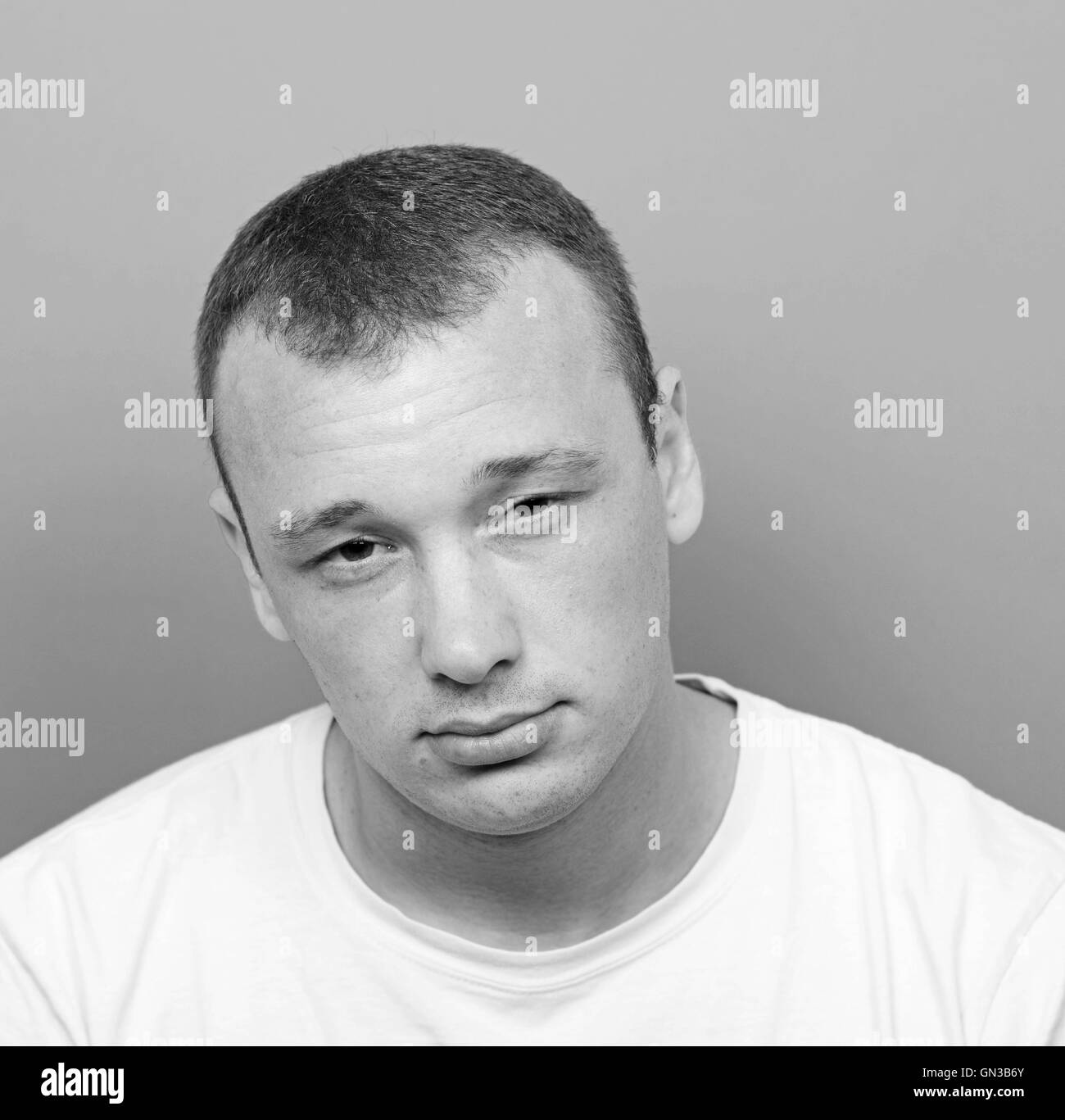 Portrait of tired man against yellow background Stock Photo