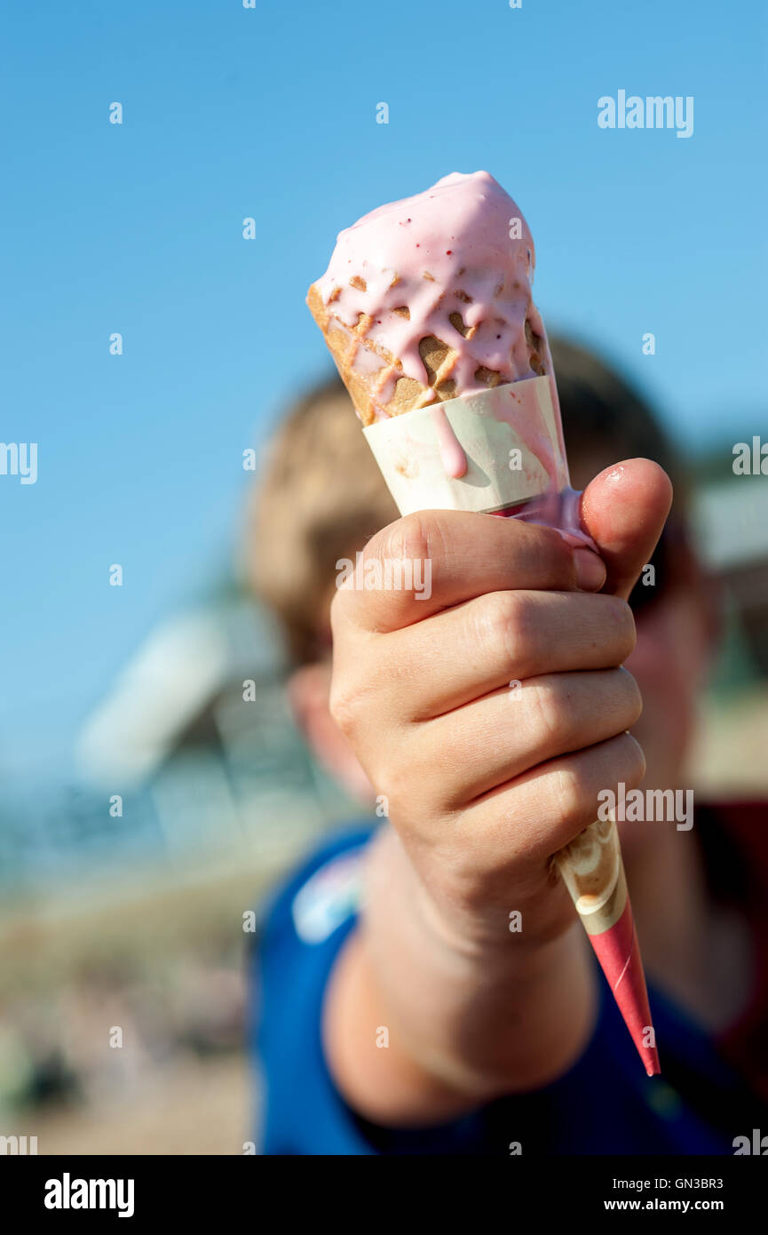 Young boys enjoying a refreshing ice-cream cone. Stock Photo