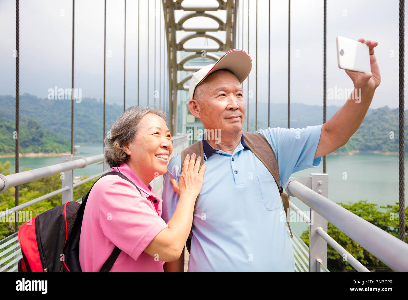 happy senior couple taking picture with smart phone selfie Stock Photo ...