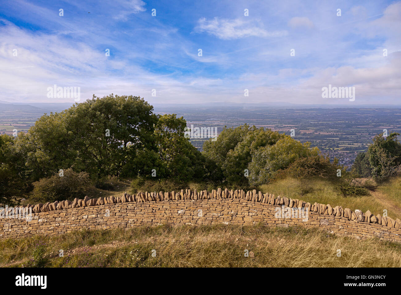 Panoramic view from Broadway Hill, near the village of Broadway, UK, Summer, evening sun, Cotswold stone wall in foreground Stock Photo