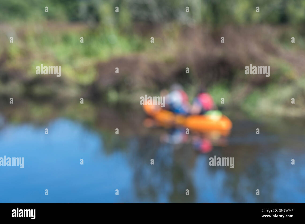 Blurry soft image of two canoeists as visual metaphor for concept of recreational / outdoor activities and leisure time. Stock Photo