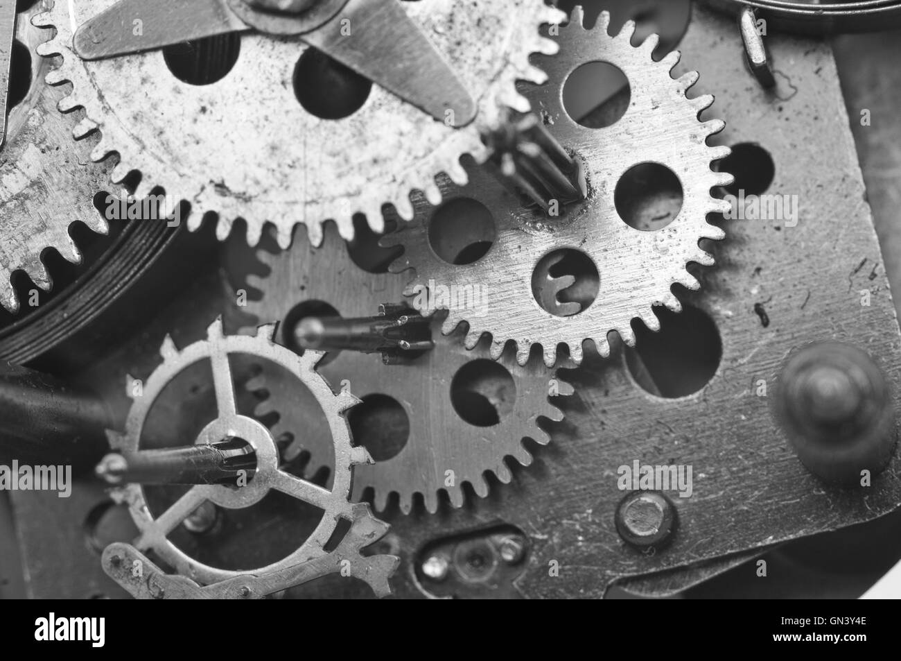 Black white Metal Cogwheels Inside Old Clockwork to success concept for your technology design. Macro Stock Photo
