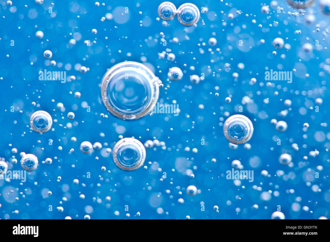 Macro Oxygen bubbles in blue clear water, concept such as ecology, environment, clean sea, potable water Stock Photo