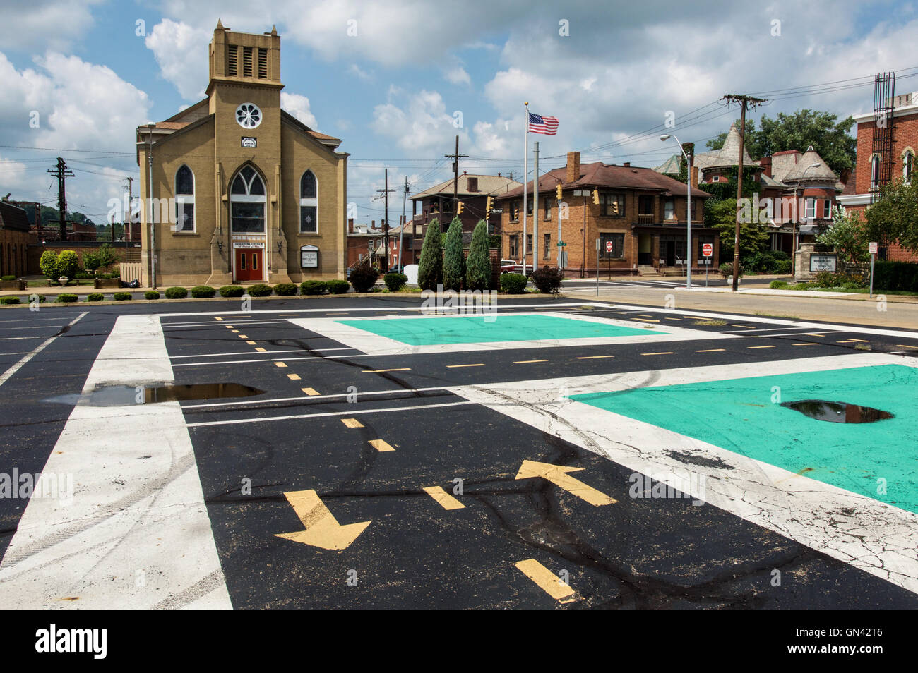 Arrows point in opposing directions in a parking lot next to a historic church in Zanesville, Ohio. Stock Photo