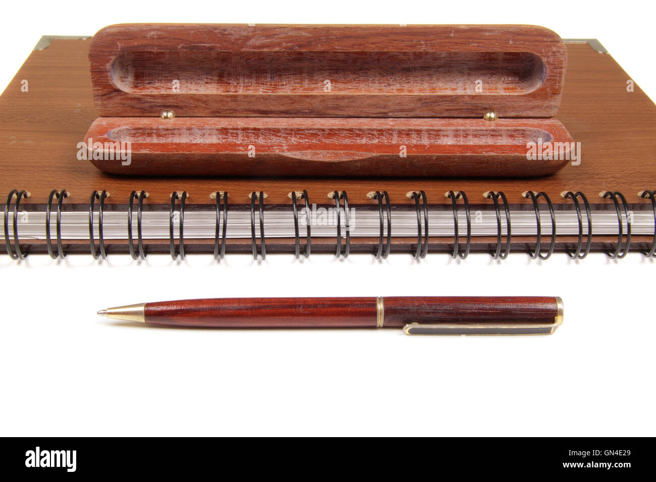 pen in an opened wooden case on notebook Stock Photo