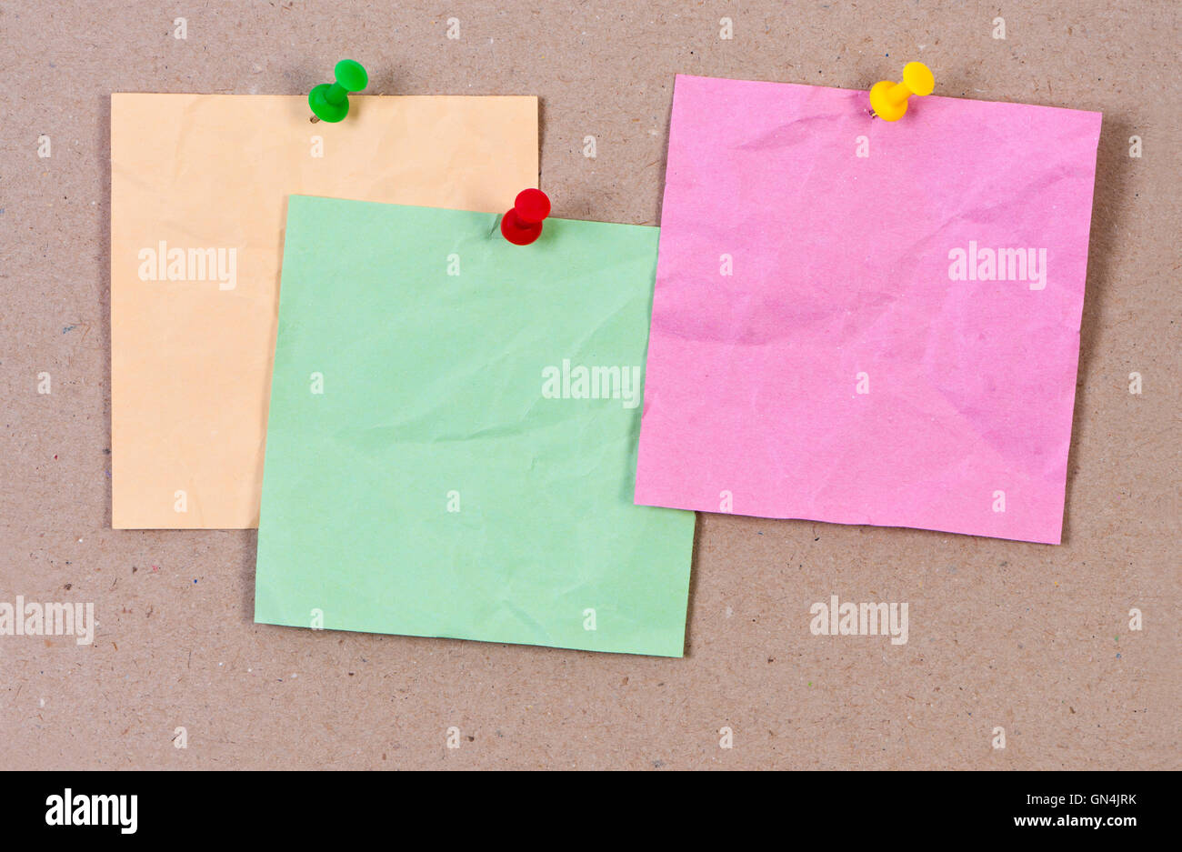 Crumpled sticky notes attached thumbtack. Stock Photo